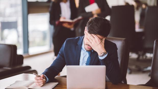 stressed businessman at laptop