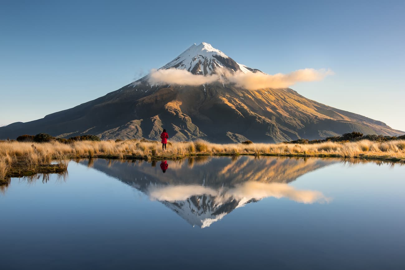 Montanha com neve refletida na água