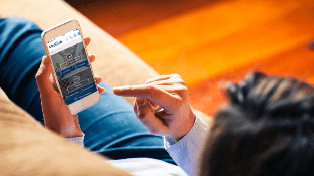 Person using MediHub app on smartphone