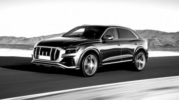 Black and white SUV driving fast