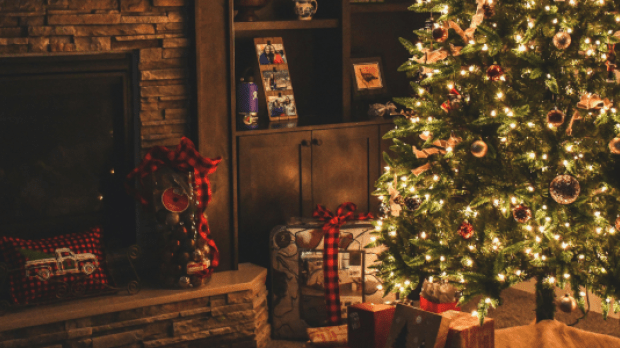 christmas tree by the fireplace with presents 