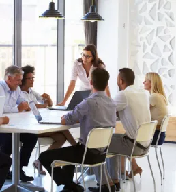 Businesswoman presenting to colleagues at a meeting