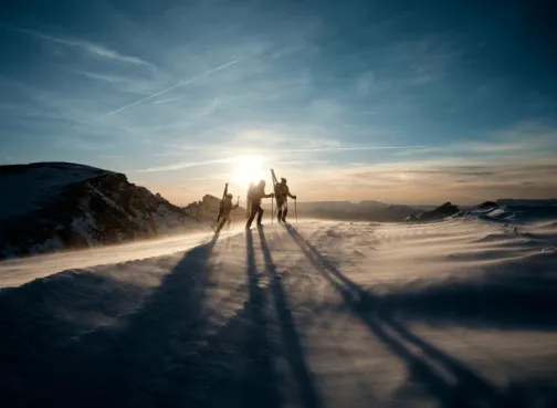 Three people hiking in the snow